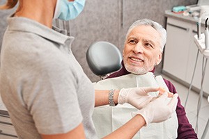 a dentist and patient talking about dentures