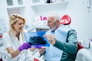 Smiling man admiring his new dental implants in Palm Bay