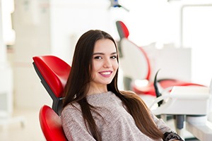 Woman with long hair smiling in dental chair