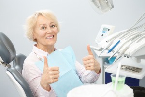 Senior woman giving a double thumbs up