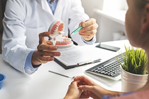 dentist discussing the cost of dentures in Palm Bay with a patient 