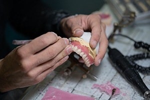 Dental lab technician working on dentures