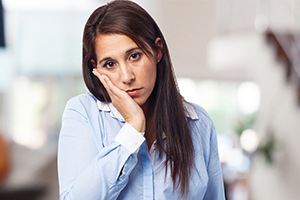 Woman with a toothache before emergency dentistry