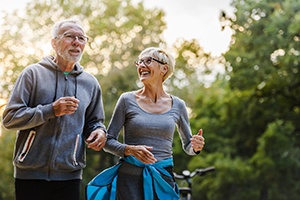 Older couple enjoying benefits of dental implants in Palm Bay