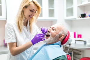 dental hygienist cleaning a patient’s teeth