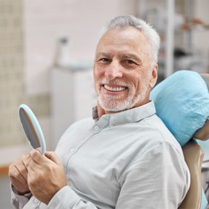 man smiling after getting dental implants