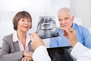 Implant dentist in Palm Bay speaking with an older patient