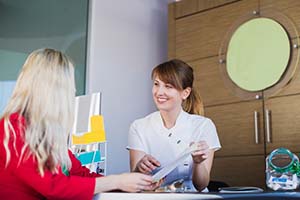 dental team member going over a patient’s insurance benefits