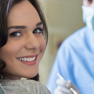 Woman breaking into a smile during dental examination