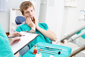 Man in pain in the dental chair before root canal