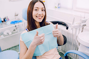 Happy woman in the dental chair after root canal therapy