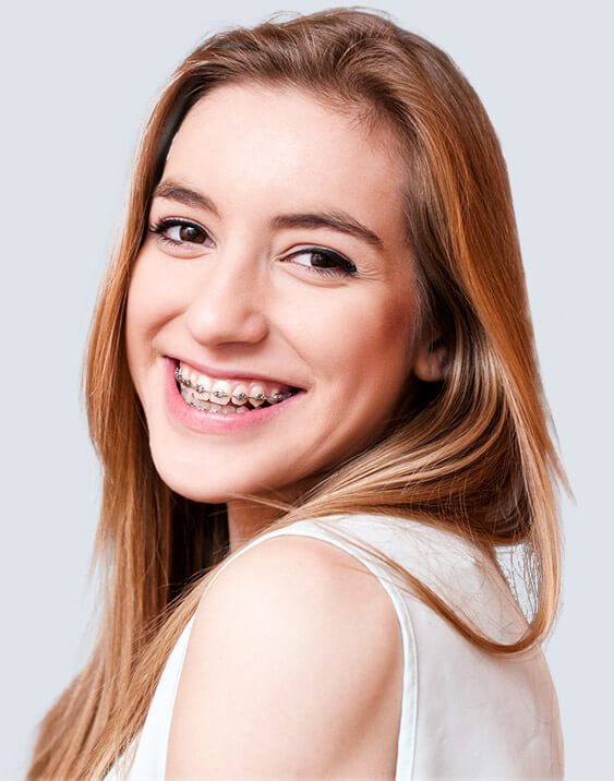 Young lady with red hair and braces smiling brightly