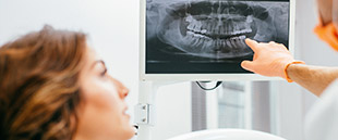 Dentist showing female patient her x-ray