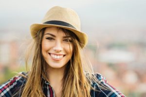 woman smiling wearing hat