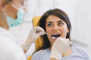 a female patient having her teeth and gums checked