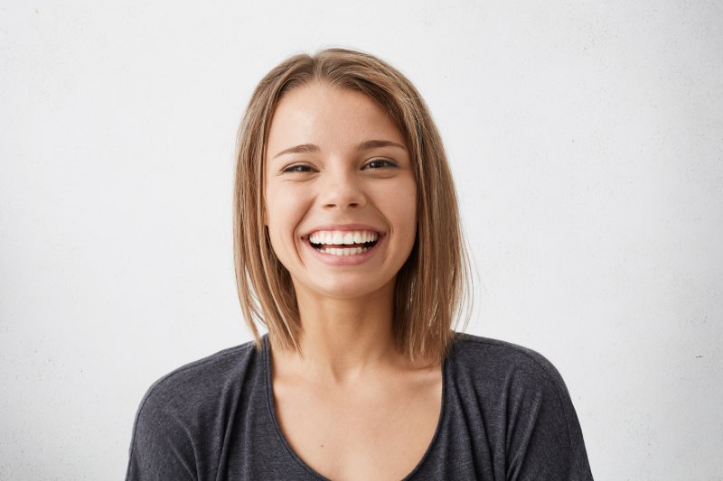 person who underwent dental implant surgery smiling