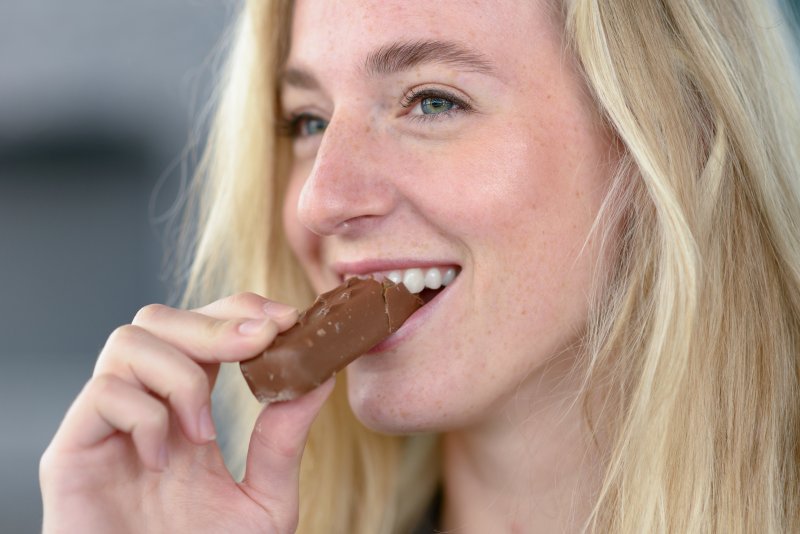 Woman eating a candy bar